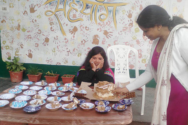 Girl behind table with cake