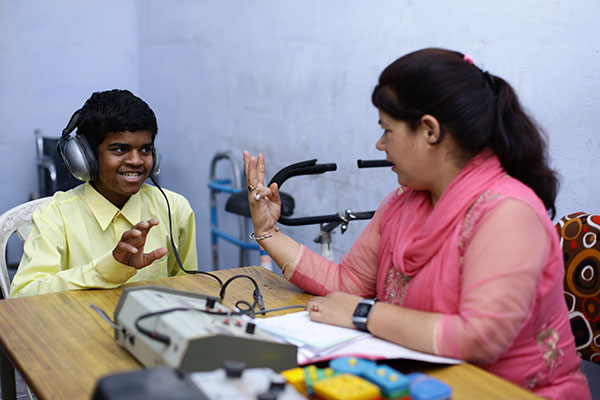 Boy with headphones learning sign language