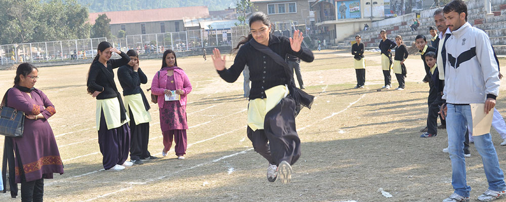 Woman jumping in the air with others standing around watching her