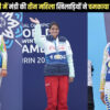 Three women athletes standing on a podium wearing medals won at the Special Olympics World Winter Games